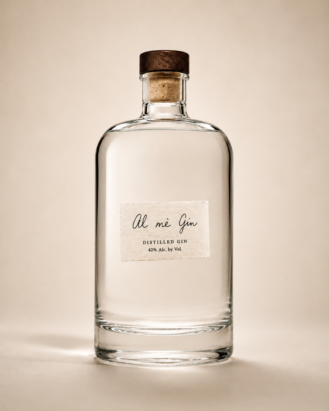 Clear Al Mè Gin bottle with a handwritten cream label and dark walnut-topped cork